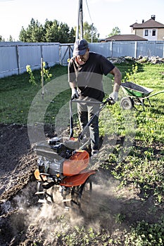 Man plowing land tillers, gardening and farming