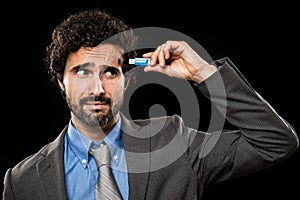 Man plugging a memory stick in his head