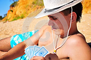 Man plying cards on the beach