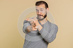 Man pointing around with finger gun gesture, making choice, shooting killing pistol right on target