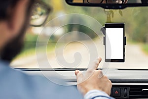 Man pointing on blank smartphone screen in car windshield holder