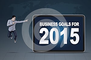 Man pointing at business goals for 2015