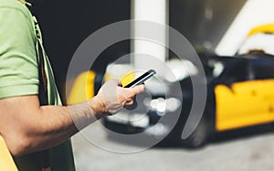 Man pointing finger on screen smartphone on background yellow taxi, tourist hipster using in hands mobile phone, person connect