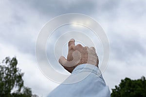 Man pointing finger at the strange lights in the sky, three light orbs among the clouds