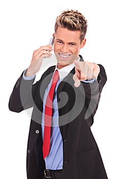 Man pointing with finger while talking on the phone