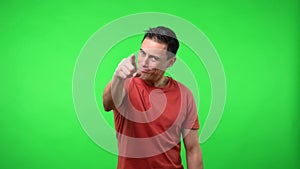 Man pointing a finger at you. Chroma green background.
