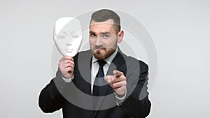 Man pointing finger on you holding mask with unknown face.