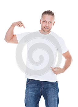 Man pointing at his blank white t-shirt