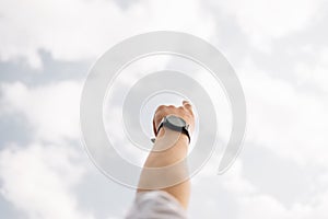 Man pointing his hand and cloud sky background