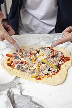 Man pointing at homemade pizza