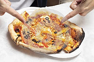 Man pointing at just made homemade pizza