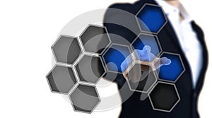 Man pointing to a glows blue hexagon button.