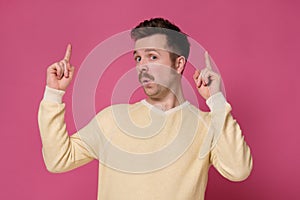 Man pointing up with his finger advicing to make a right choic photo