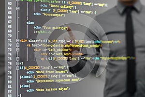 Man pointing on virtual screen with website programming code photo