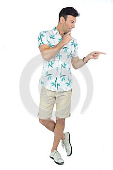 Man points to the side and makes his decision. Handsome brazilian male wears floral shirt..