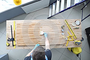 A man polishing a board with varnish top view