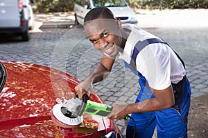 Man Polishing Car With Orbital Polisher photo