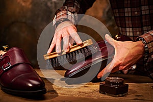 Man polishing leather shoes with brush