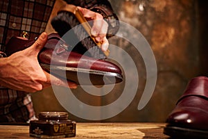 Man polishing leather shoes with brush