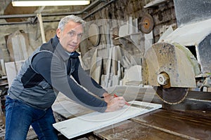 man polishing marble stone table by angle grinder