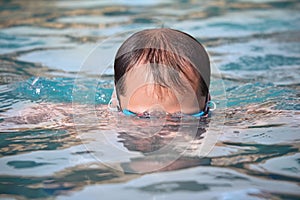 Man in pool, dives under water photo