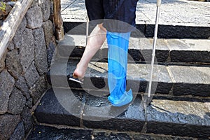 Man in the pool with waterproof leg plaster protection