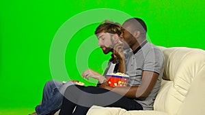 Man with popcorn watching television. Green screen
