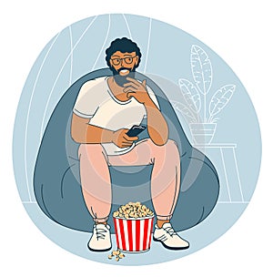 Man with popcorn is watching TV