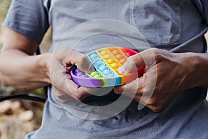 Man popping some bubbles of a destressing toy