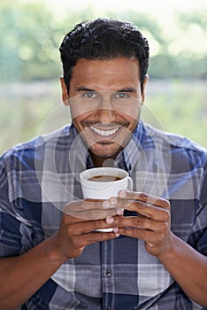 Man, portrait and coffee to relax in home, smile and satisfaction with hot beverage on weekend. Male person, happy and