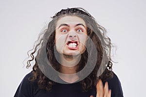 Man, portrait and crazy in studio, mouth and comic or funny expression on grey background. Comedian, awkward and quirky