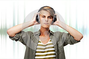 Man, portrait and DJ with headphones or audio waves listening to music against a studio background. Young male person or