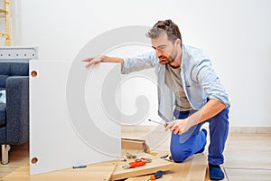 Man portrait and do it yourself furniture assembly