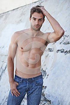 Man, portrait and fitness body with confidence, stomach and wellness outdoor by a wall. Summer, workout and smile of a