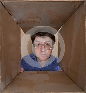 Man portrait inside carton box