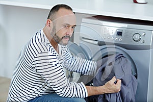 Man portrait thinking about washing machine