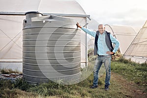 Man, portrait and water tank in farming liquid or soil hydration for vegetables, food and crops growth. Irrigation