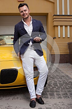 Man posing with convertible sportcar