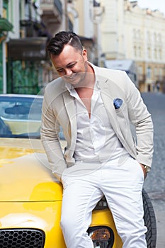 Man posing with convertible sportcar