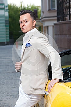 Man posing with convertible sportcar