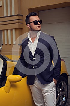 Man posing with convertible sportcar