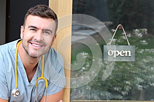 Man posing at doctorÃÂ´s office entrance photo