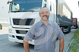man posing in front cargo truck
