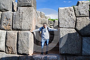 Man posing in front of the huge rocks of Sacsayhuaman in Cusco - Peru