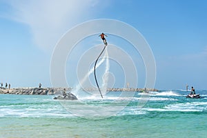 Man posing at new flyboard at Caribbean tropical beach. Positive human emotions, feelings, joy. Funny cute men making vacations an