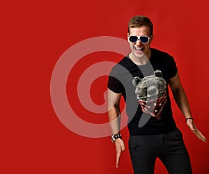 Man posing on red background screaming happy smiling