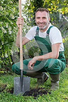 man posing with shovel