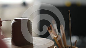 A man potter connects parts on a clay teapot. Handwork. Craft work concept. Pottery for tea ceremony