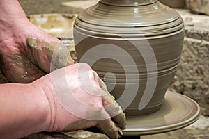 Man potter at work creating some traditional cups of white clay, Lassithi, Crete, Greece. photo