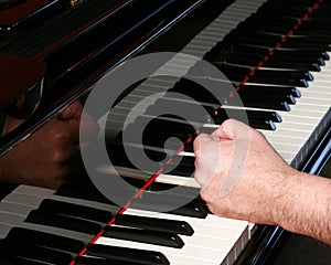 Man pounding fist on piano